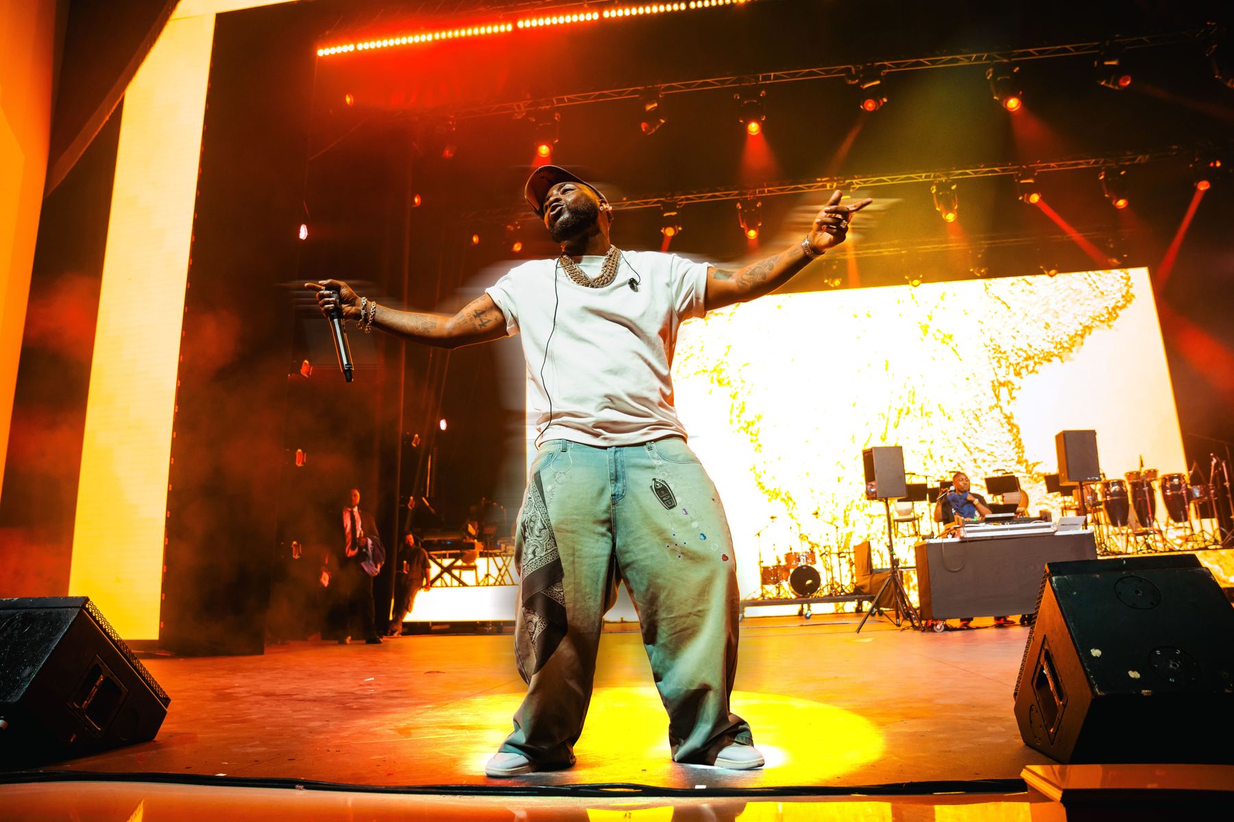 Performer on stage with arms outstretched