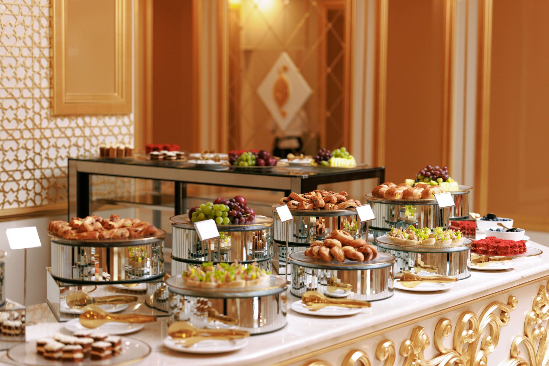 Pastry and dessert buffet on a gilded counter